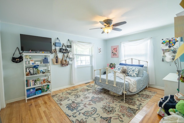 bedroom with ceiling fan and light hardwood / wood-style floors