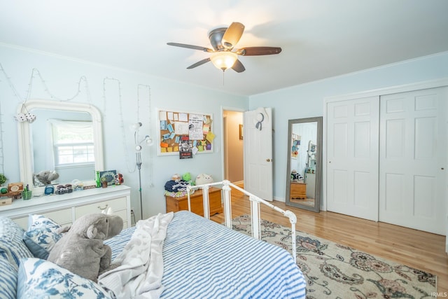 bedroom featuring light hardwood / wood-style floors, ceiling fan, and a closet