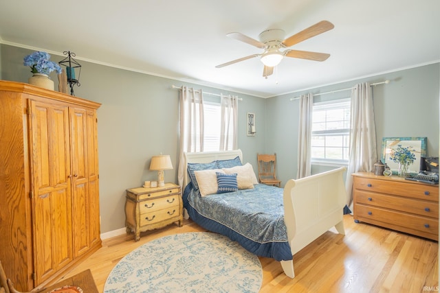 bedroom featuring ceiling fan, light hardwood / wood-style floors, and ornamental molding