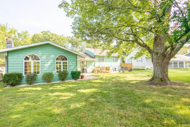 back of house with a lawn