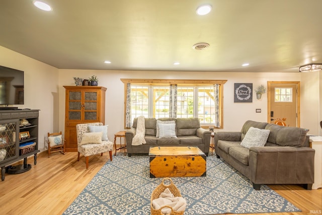 living room with light hardwood / wood-style flooring