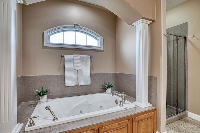 bathroom with separate shower and tub, decorative columns, and tile patterned flooring