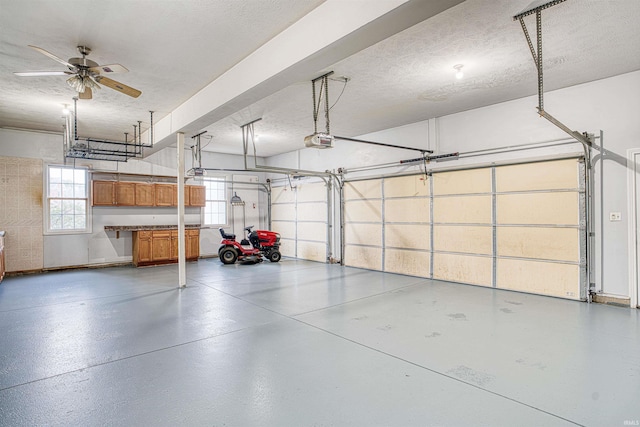 garage featuring ceiling fan and a garage door opener