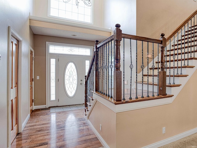 foyer entrance featuring a high ceiling and hardwood / wood-style floors