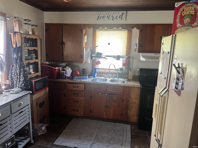 1112 E Fourth St, Mount Vernon, IN 47620 - kitchen featuring freestanding refrigerator, under cabinet range hood, black / electric stove, a sink, and dark tile patterned flooring