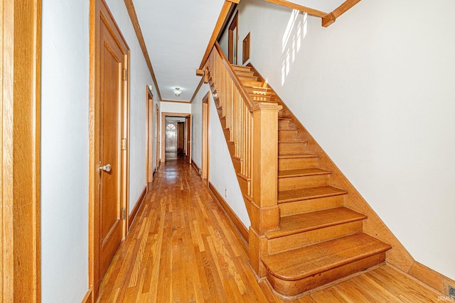 stairway featuring hardwood / wood-style flooring and ornamental molding