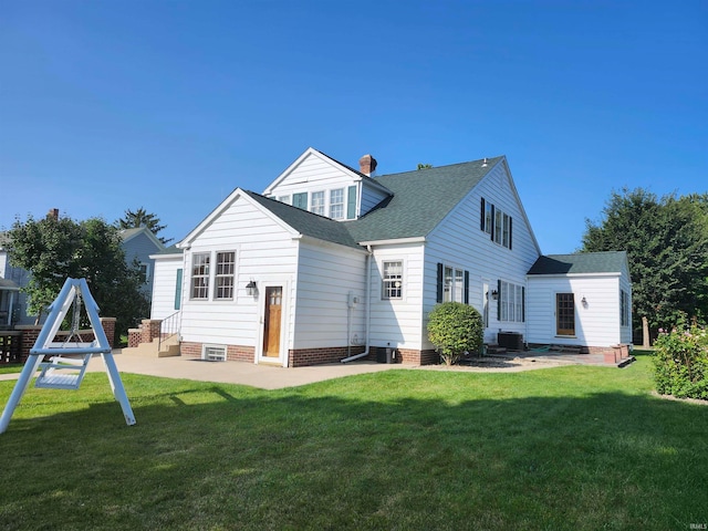 rear view of property featuring a yard and central air condition unit