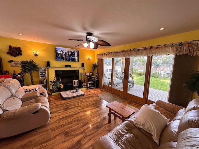 living room with ceiling fan and wood-type flooring