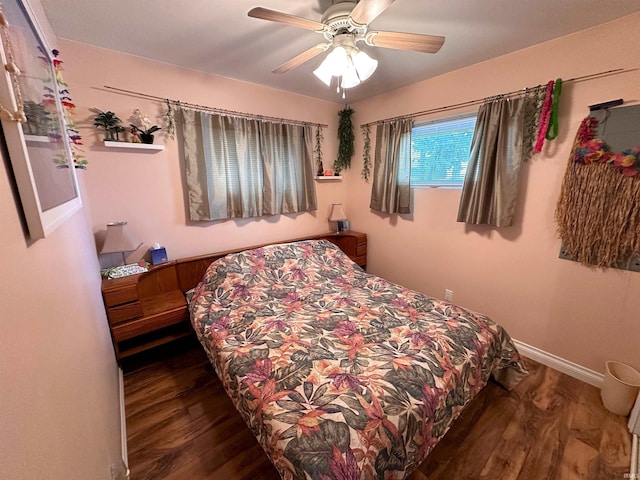 bedroom with wood finished floors, a ceiling fan, and baseboards
