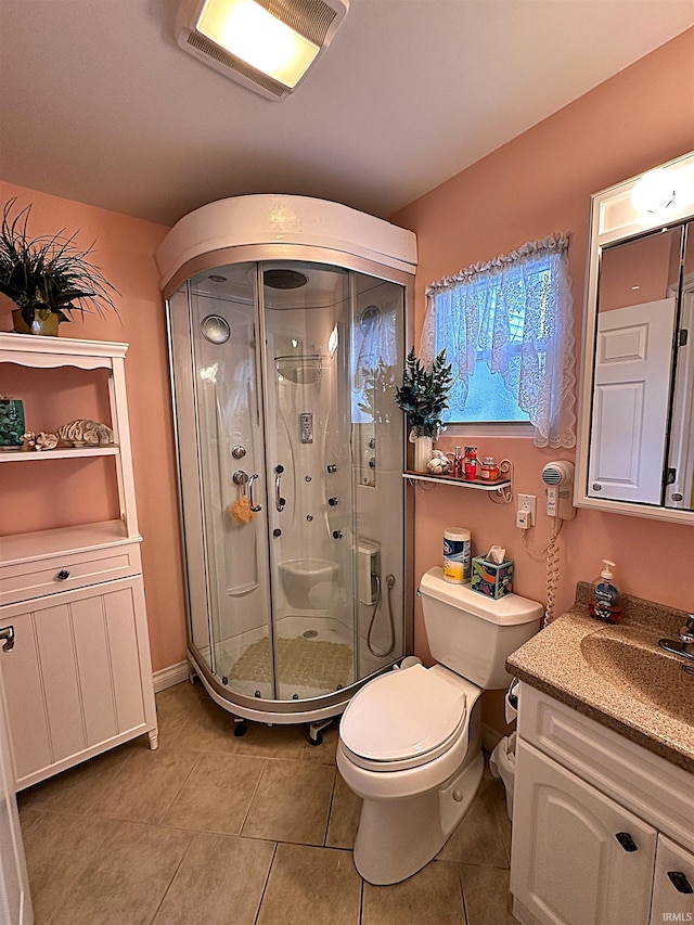 bathroom with toilet, an enclosed shower, tile patterned floors, and vanity