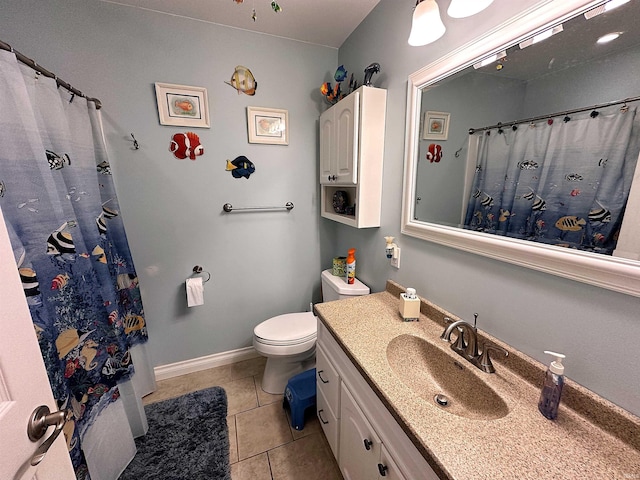 bathroom featuring tile patterned flooring, vanity, and toilet