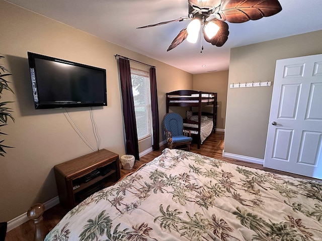 bedroom with wood finished floors, ceiling fan, and baseboards