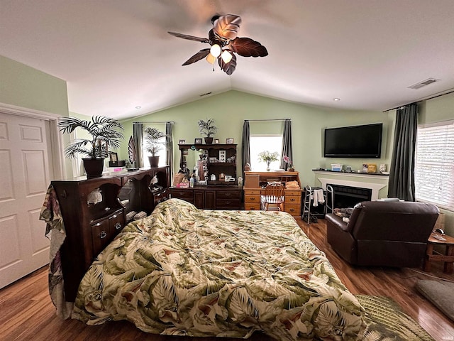 bedroom featuring ceiling fan, wood-type flooring, and lofted ceiling