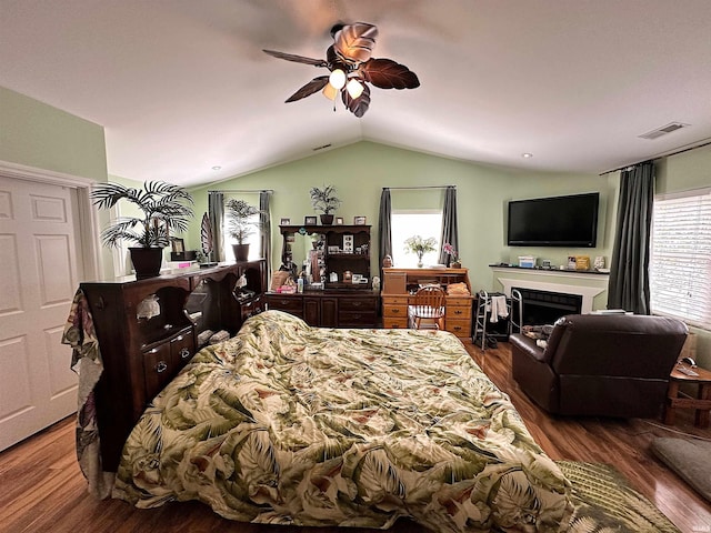 bedroom with visible vents, wood finished floors, and multiple windows