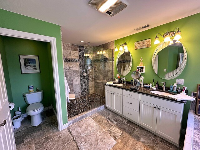 bathroom with tile patterned floors, toilet, double vanity, and an enclosed shower