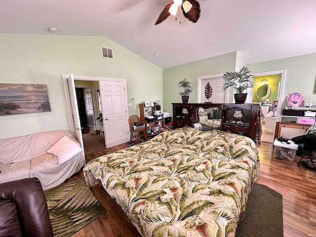 bedroom featuring visible vents, wood finished floors, a ceiling fan, and vaulted ceiling