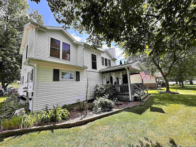 exterior space featuring a porch and a lawn