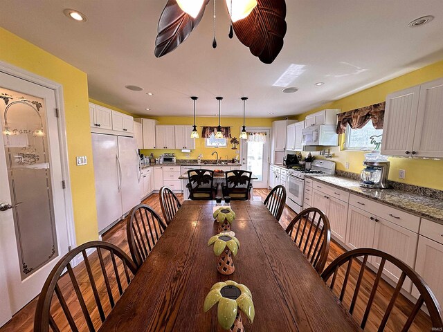 dining room with ceiling fan and wood-type flooring