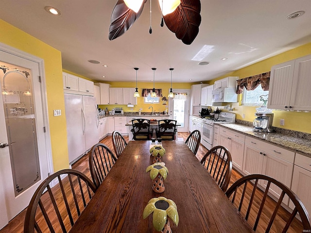 dining space featuring recessed lighting and dark wood-type flooring