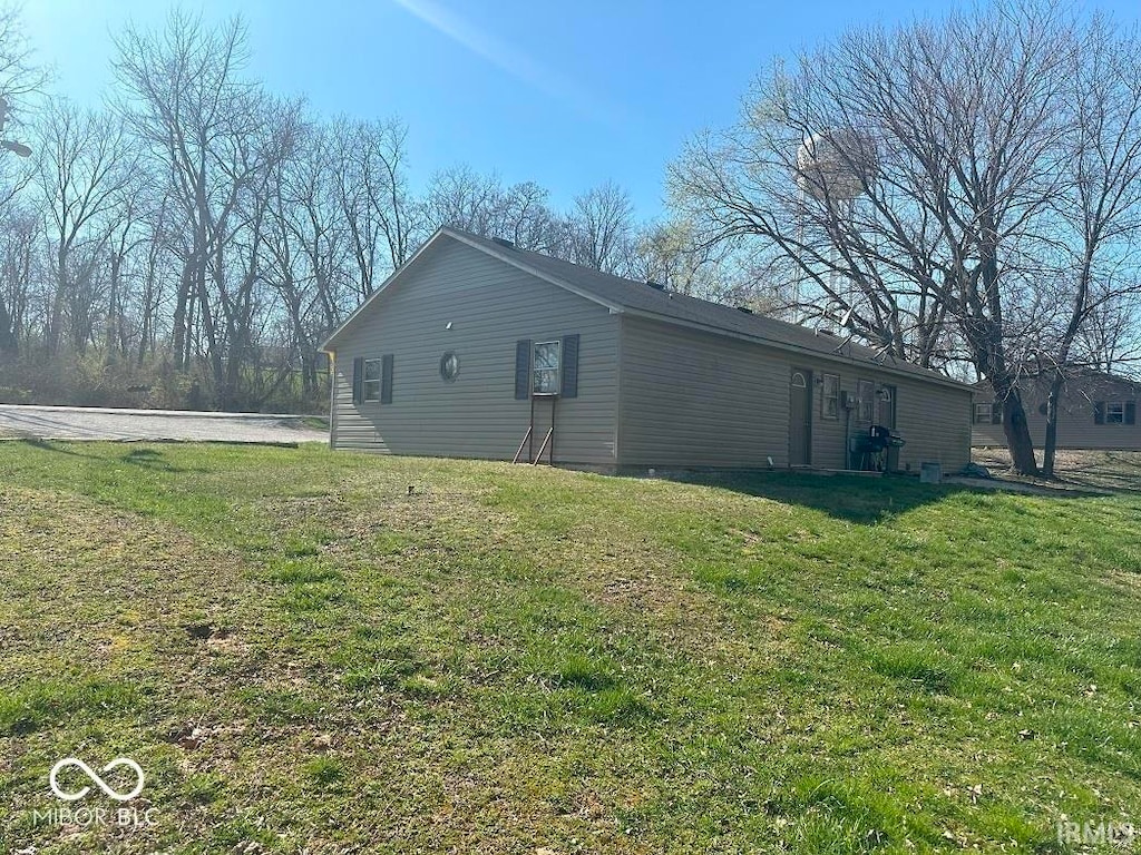 view of side of home featuring a yard