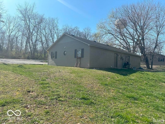 view of side of home featuring a yard