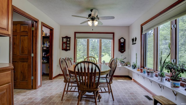 dining area with visible vents, plenty of natural light, and a textured ceiling