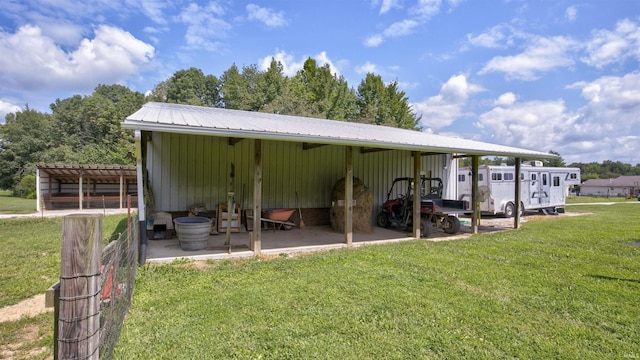 exterior space with an outbuilding and a lawn