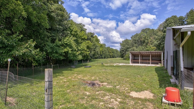 view of yard with an outbuilding and fence