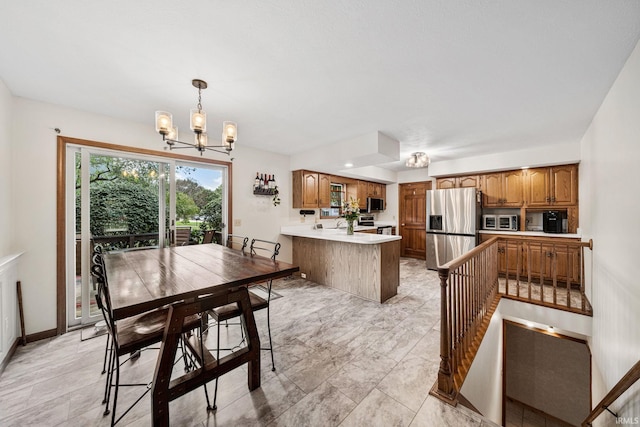 dining area featuring a notable chandelier and light tile patterned flooring