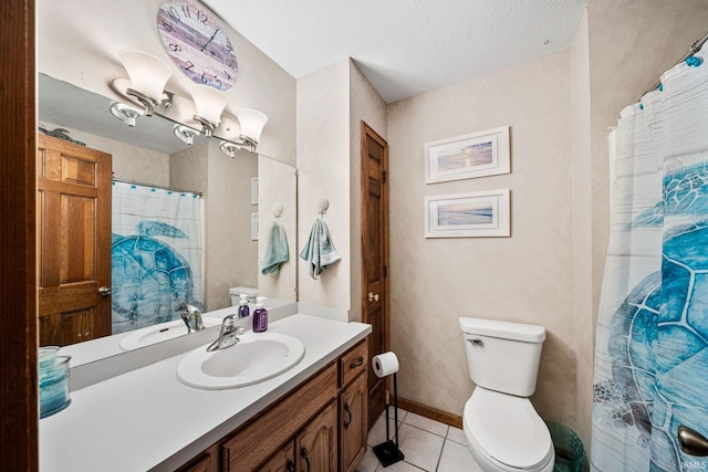 bathroom featuring tile patterned floors, a textured ceiling, vanity, and toilet