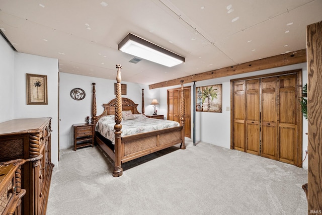 bedroom featuring light carpet and a barn door