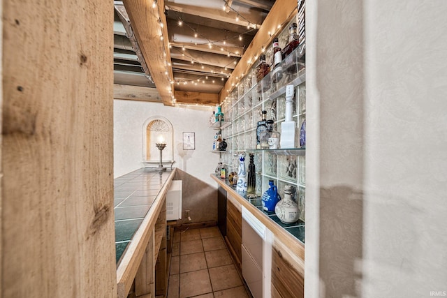 bar with tile countertops and light tile patterned floors