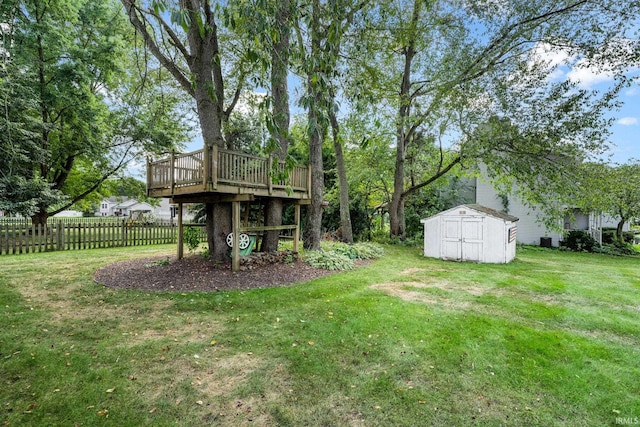 view of yard with a wooden deck and a storage shed