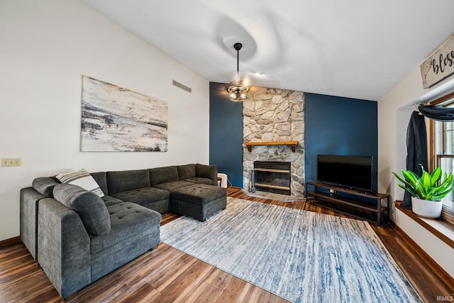 living room with hardwood / wood-style flooring, a fireplace, and ceiling fan