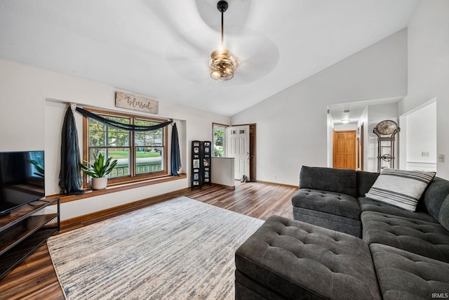 living room featuring ceiling fan, lofted ceiling, and wood-type flooring