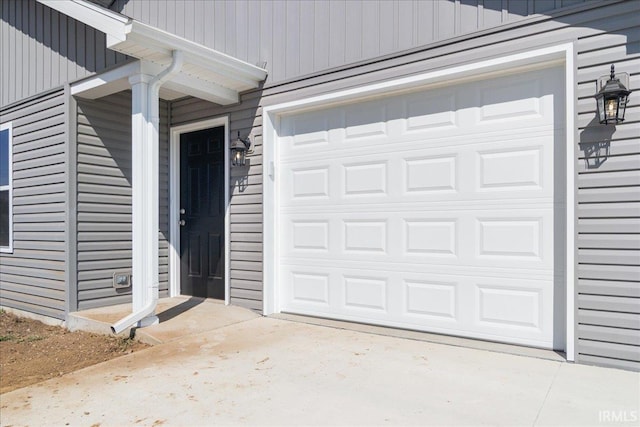 doorway to property with a garage