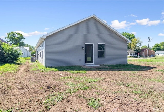 rear view of house featuring central AC