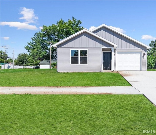 view of front of property featuring a garage, concrete driveway, and a front lawn