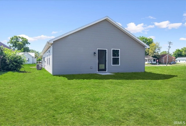 rear view of property featuring a yard