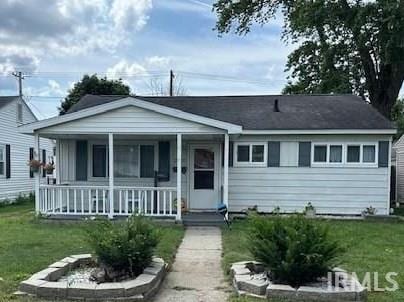 view of front of home with a front yard and a porch