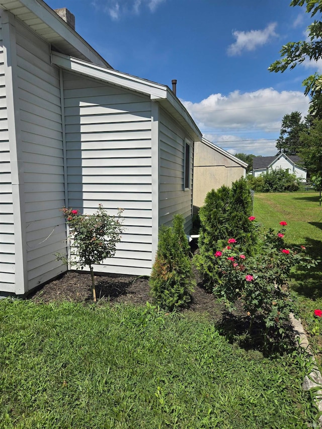 view of property exterior with a yard