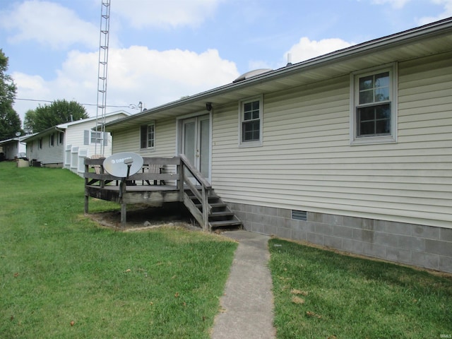 rear view of property with a yard