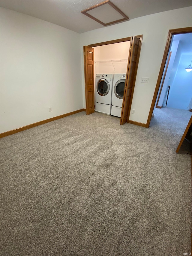 unfurnished bedroom featuring separate washer and dryer and light colored carpet