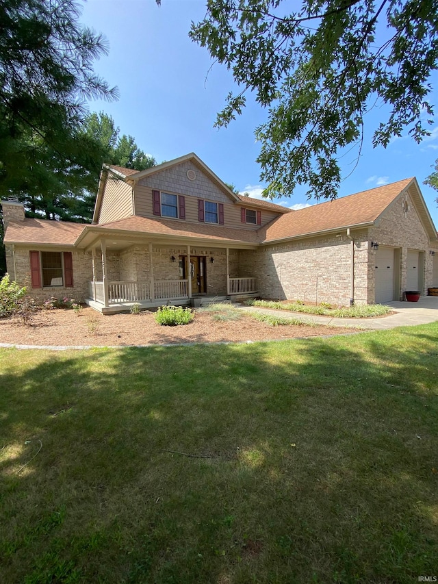 view of front of house featuring a porch, a front yard, and a garage