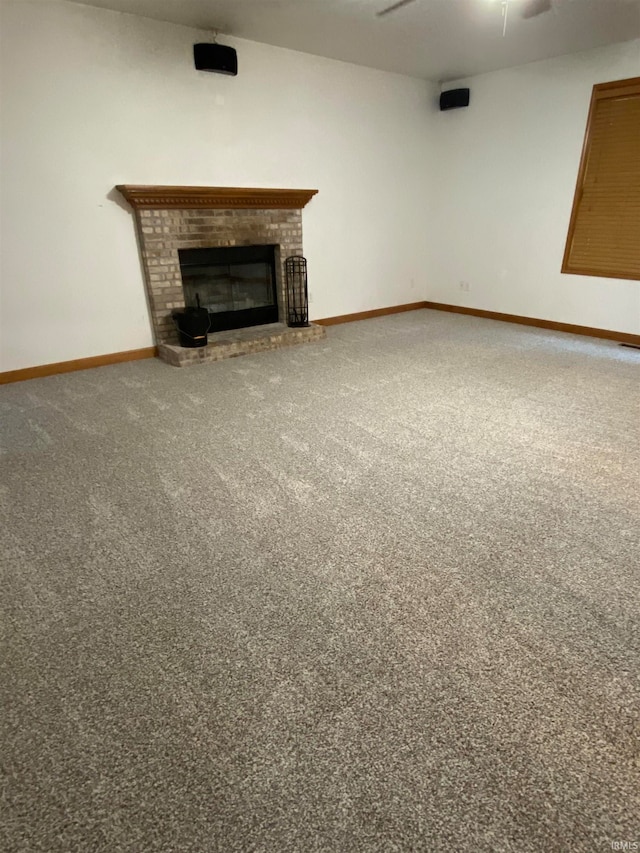 unfurnished living room featuring a fireplace and carpet flooring