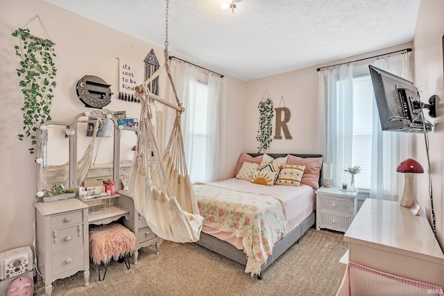 carpeted bedroom with a textured ceiling