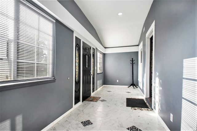 corridor featuring a healthy amount of sunlight and light tile patterned floors