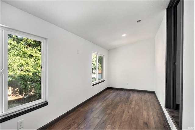 unfurnished room featuring dark wood-type flooring