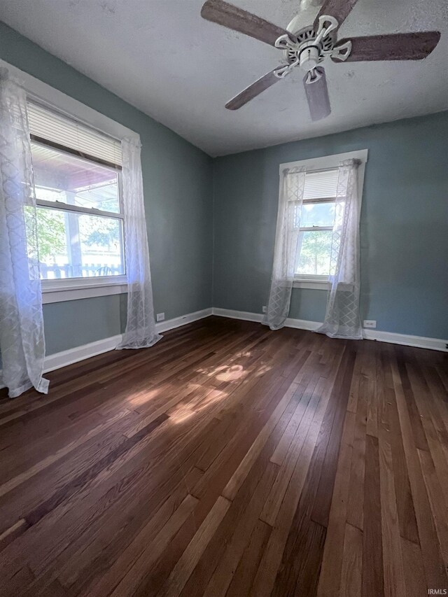 unfurnished room featuring hardwood / wood-style flooring and ceiling fan