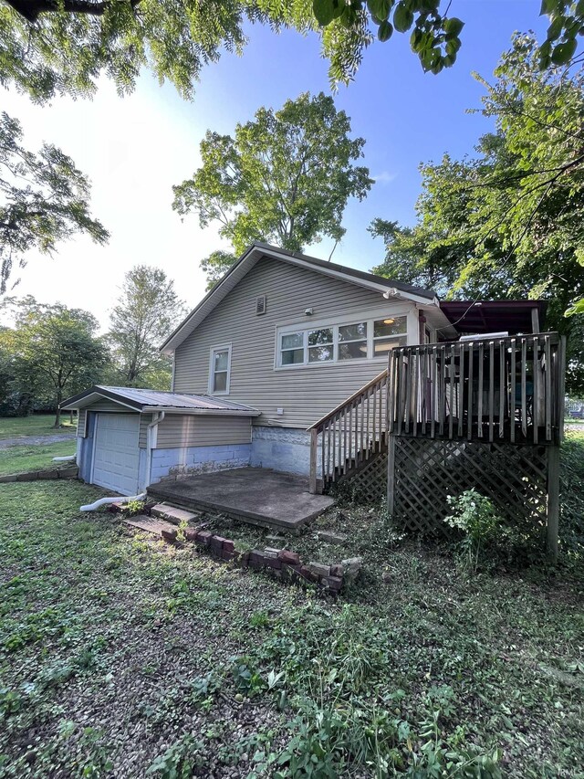 rear view of house featuring a wooden deck